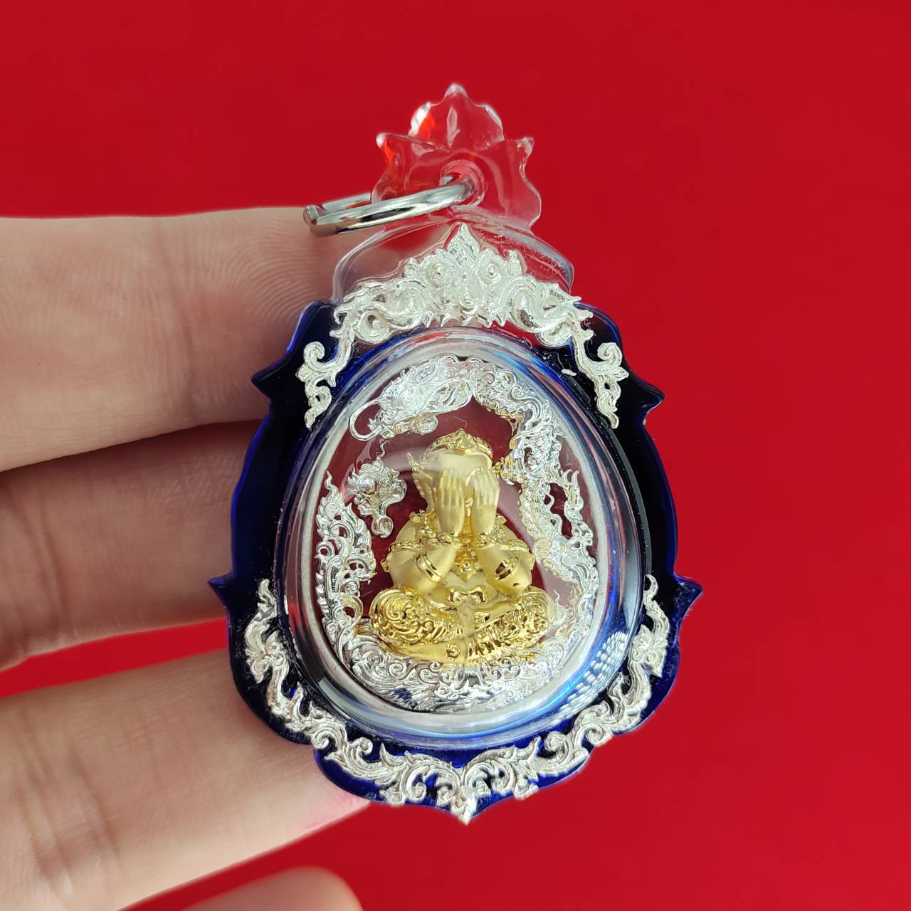 Phra Pidta amulet for wealth in a decorative casing, ideal for enhancing prosperity and luck