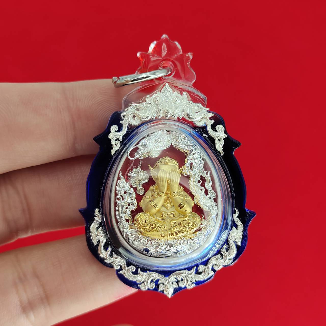 Phra Pidta amulet for wealth in ornate casing, designed for prosperity and good fortune