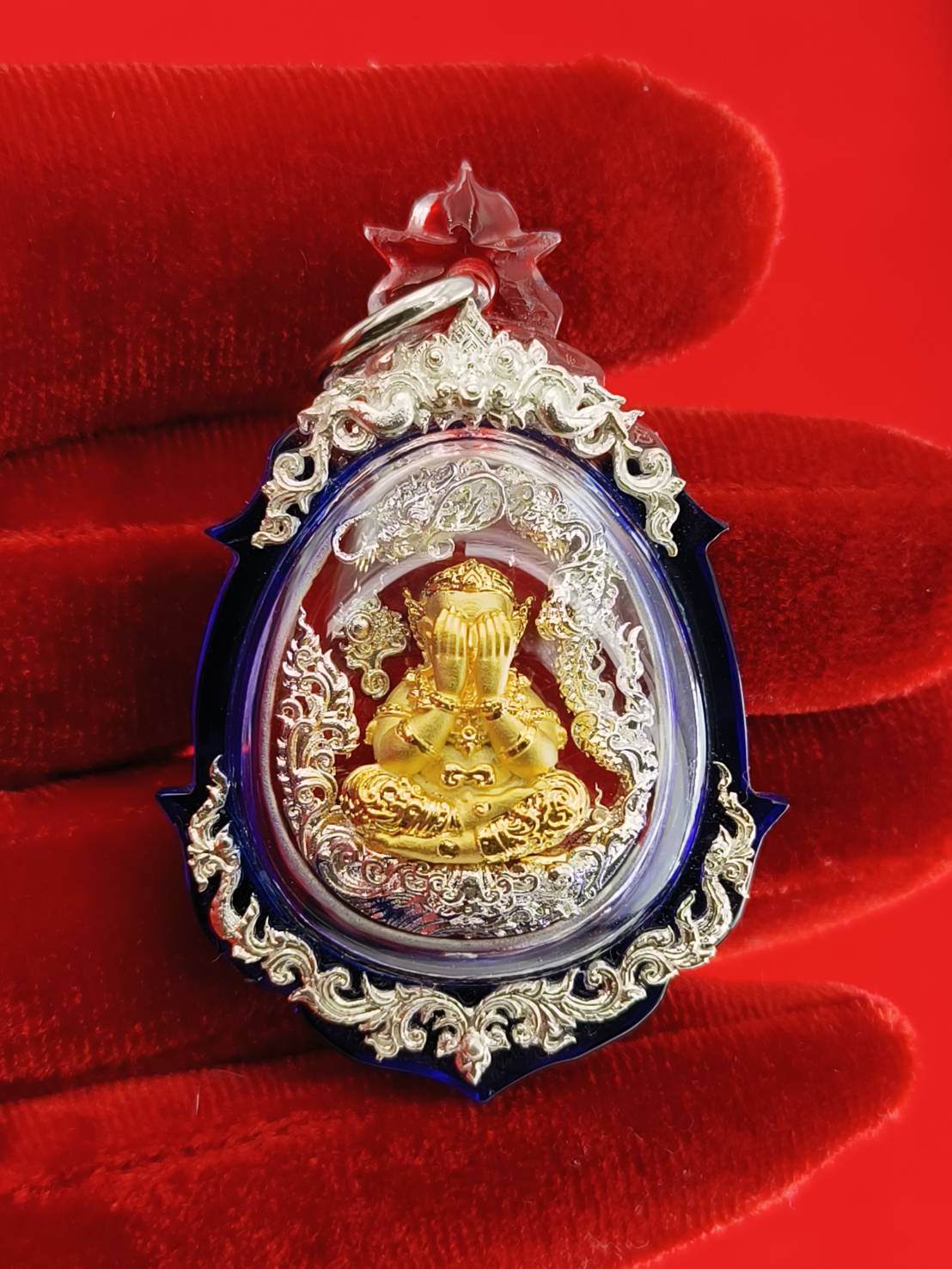 Phra Pidta amulet for wealth in ornate casing, perfect for attracting prosperity and good fortune