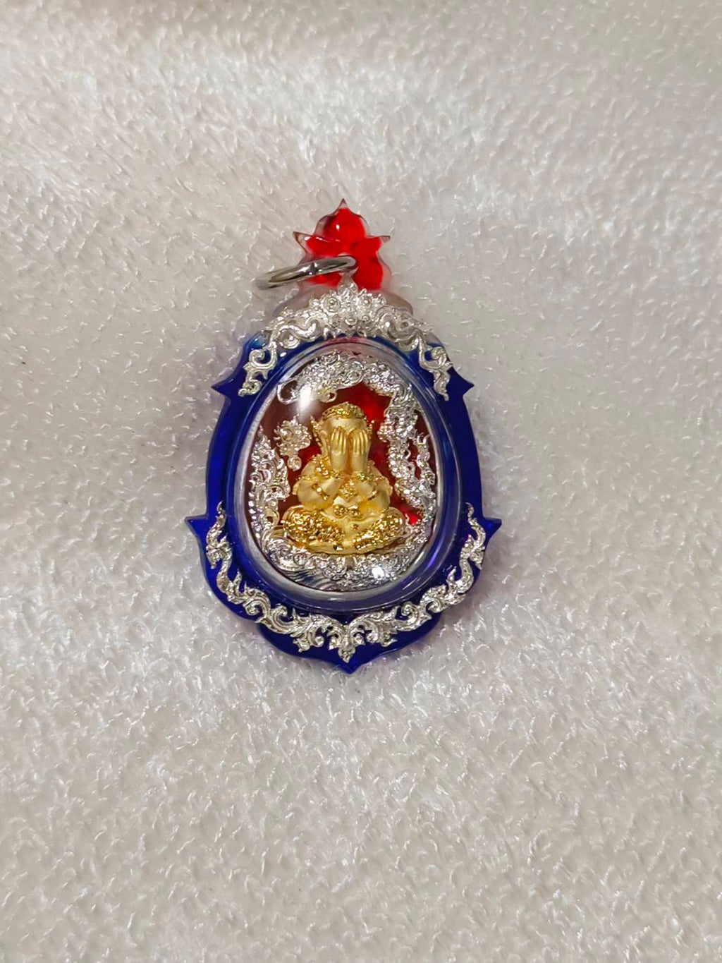 Phra Pidta amulet for wealth in a decorative frame, ideal for attracting prosperity and fortune