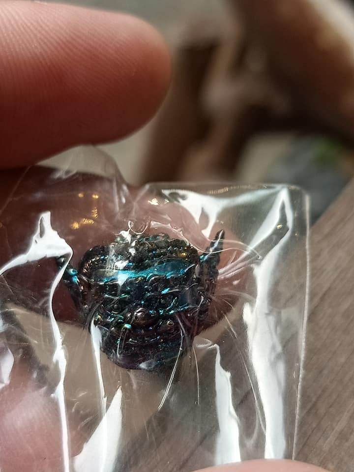 Phra Pirap amulet for power in protective packaging, showcasing intricate details and vibrant colors