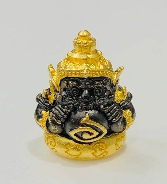 Phra Rahu amulet for luck in gold and black, crafted for spiritual protection and fortune.