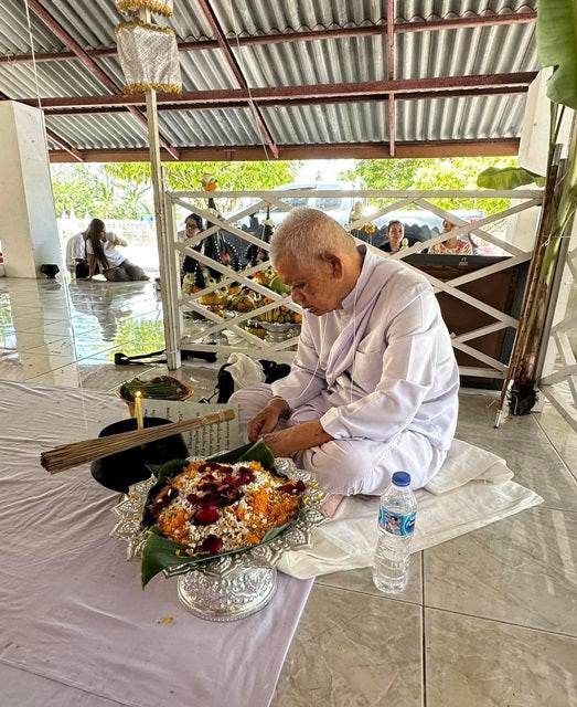 Phra Rahu amulet for luck being blessed during a spiritual ceremony for good fortune