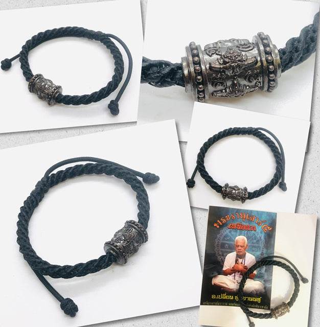 Phra Rahu amulet for luck on a black braided bracelet with intricate silver detailing