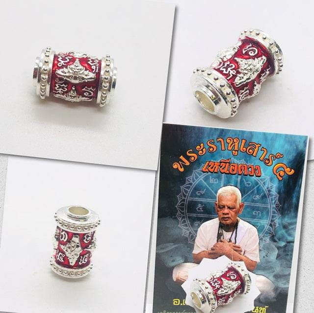Phra Rahu amulet for luck in intricate design with silver details and red accents
