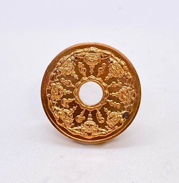 Beautiful Phra Rahu amulet for protection with intricate golden designs and a central circular opening