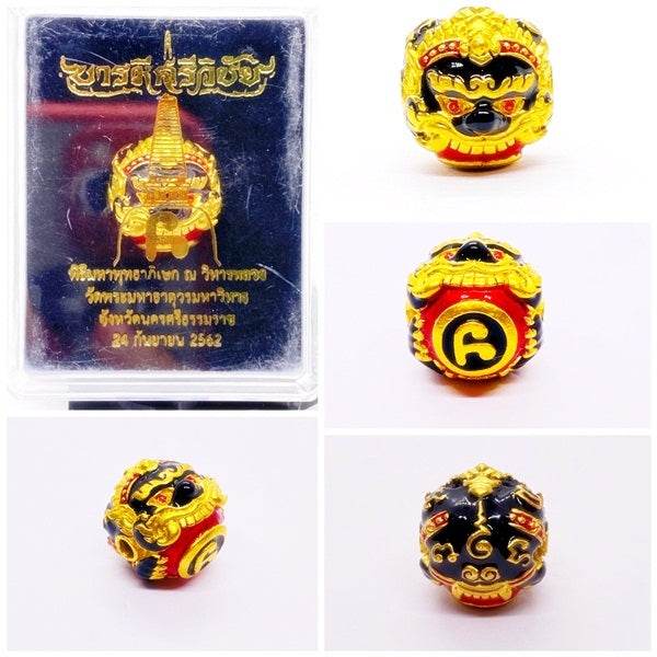 Phra Rahu Nomo Sriwichai amulet for luck in gold and red design, displayed in a protective case.