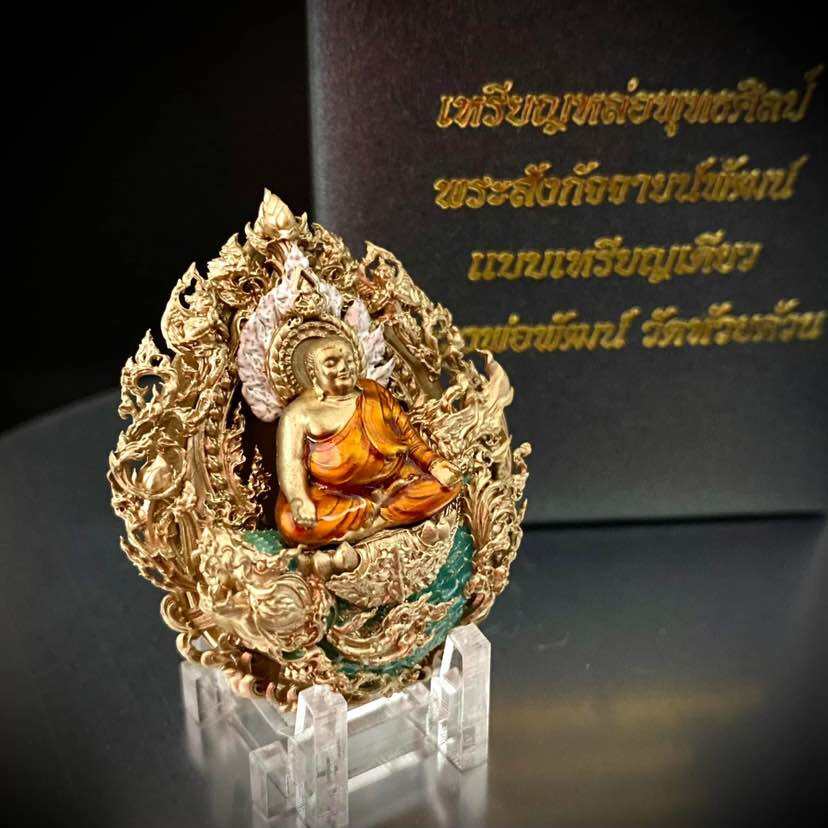 Phra Sangkajai and Phra Upakut amulet in intricate gold design on display with decorative stand