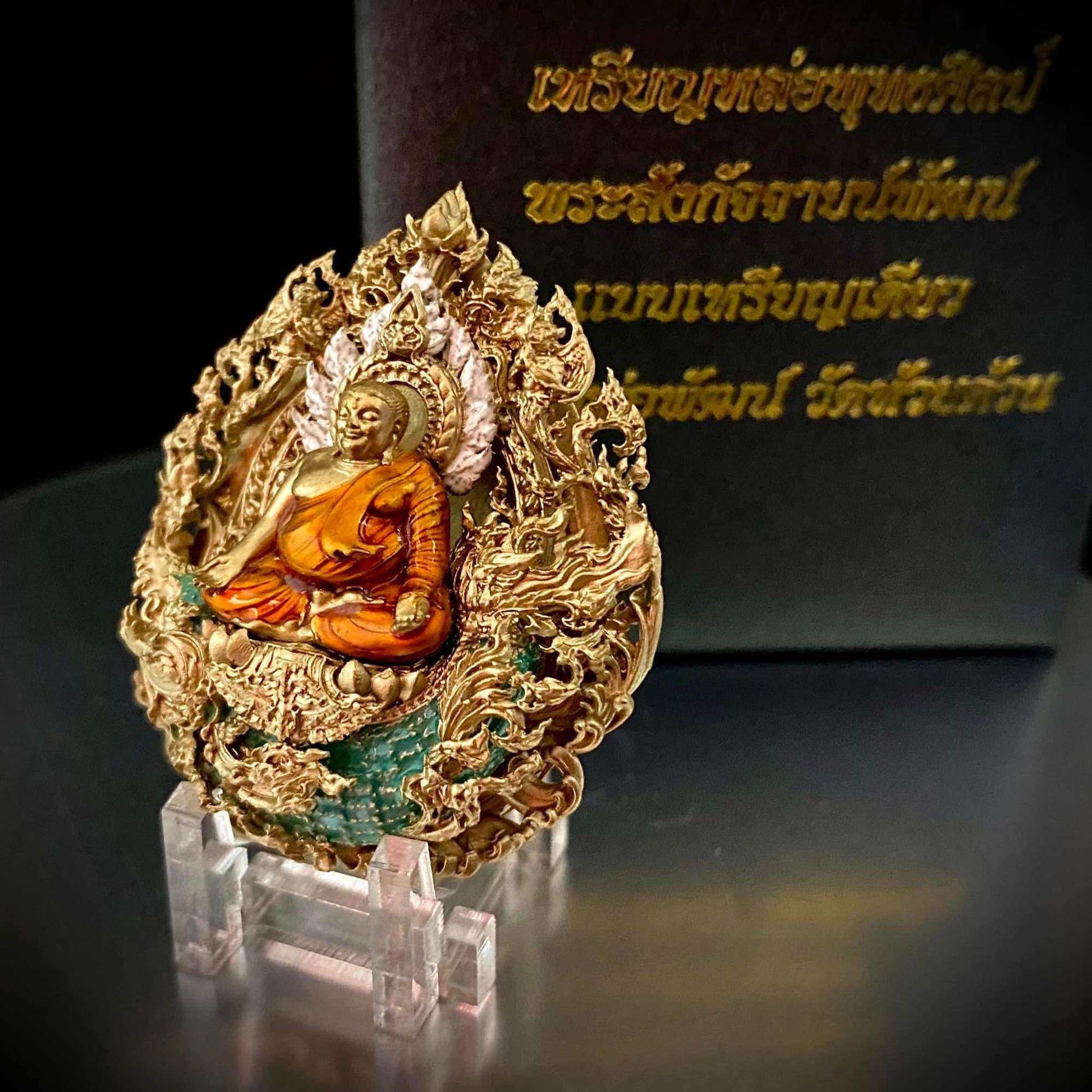 Phra Sangkajai and Phra Upakut amulet in ornate gold design with intricate detailing