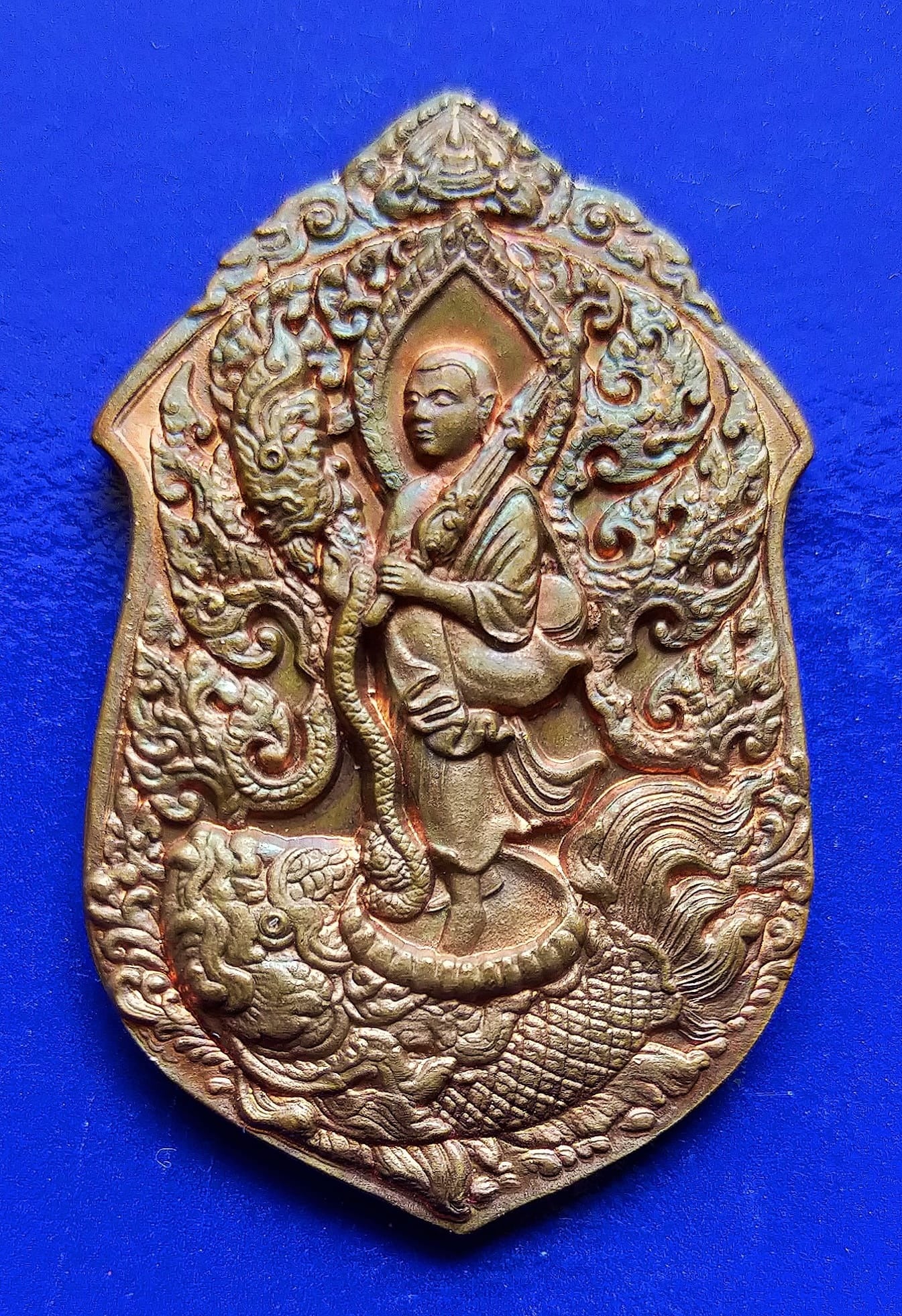 Intricately designed Phra Siwali amulet for wealth featuring a monk standing on a mythical creature