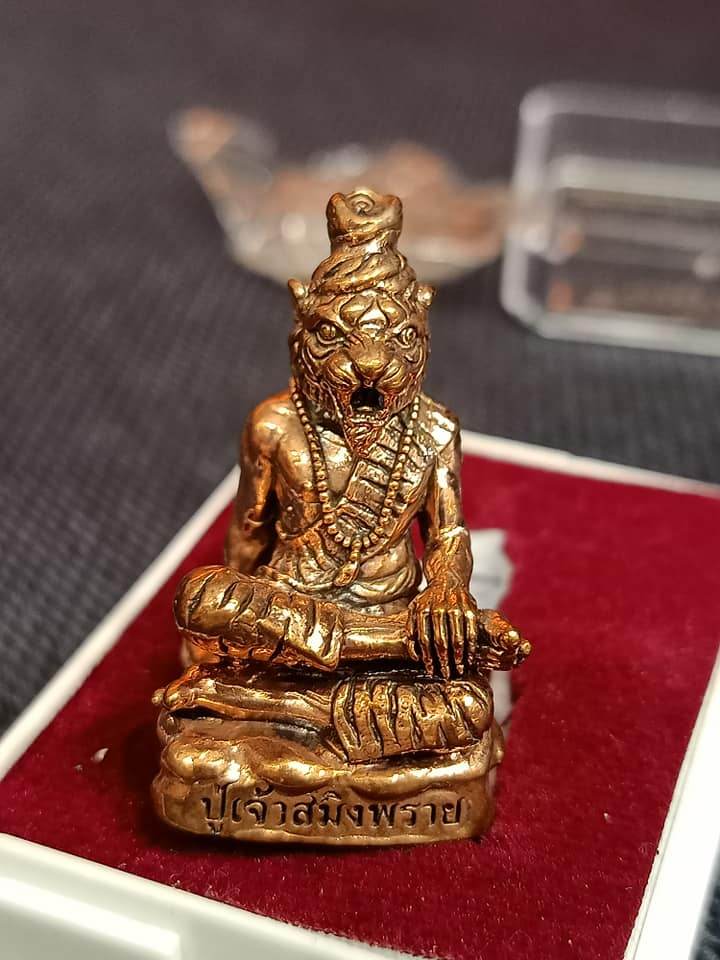 Phu Chao Saming Phrai spirit figurine in bronze, seated and adorned, promoting good fortune and protection.