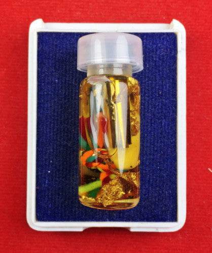 Powerful communication amulet Thailand in a small vial with colorful charms and protective elements