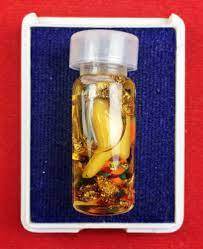 Powerful communication amulet Thailand in a small vial with golden liquid and insights for personal success