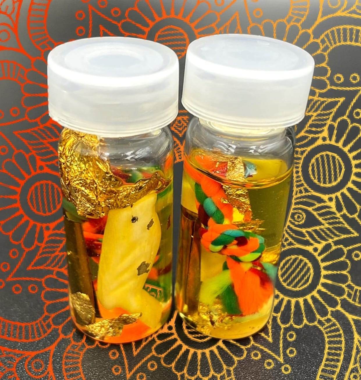 Two powerful communication amulets Thailand sealed in glass bottles for spiritual energy and good fortune