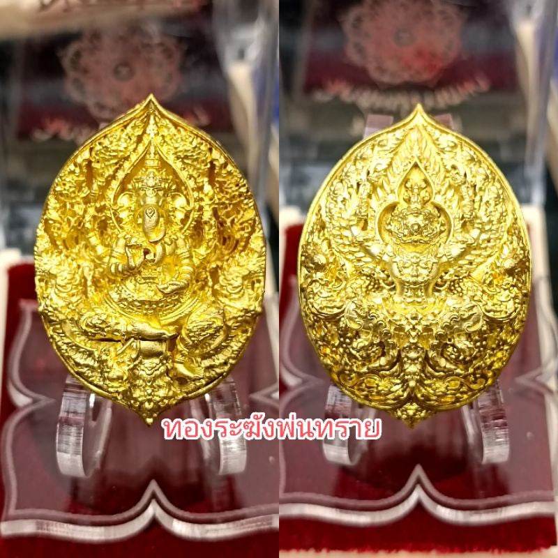 Premium Buddhist amulet for prosperity in gold with intricate design displayed on clear stands