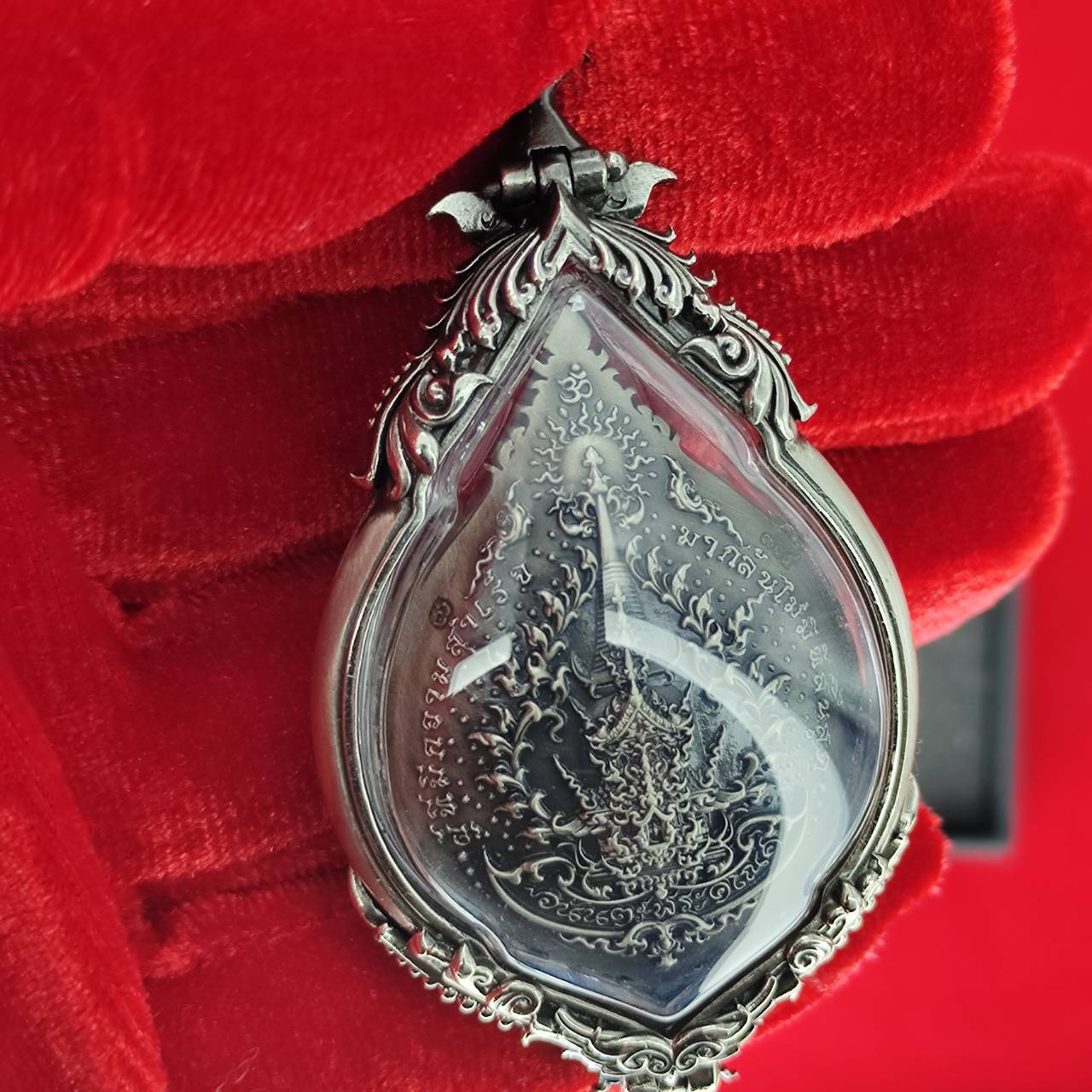 Prosperity Ganesh pendant Thailand featuring intricate designs and a clear protective stone