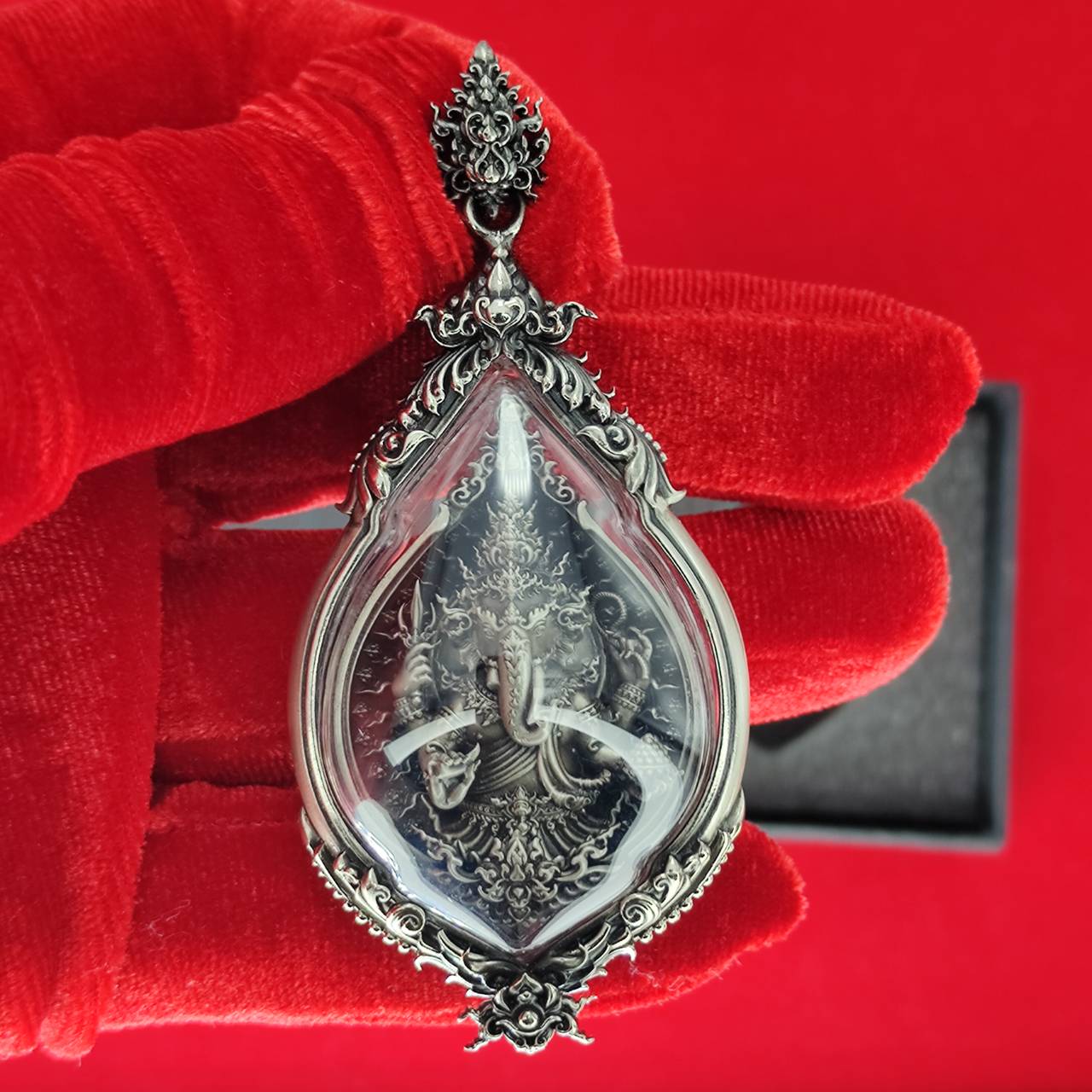 Intricate prosperity Ganesh pendant Thailand with detailed design encased in clear crystal and silver frame