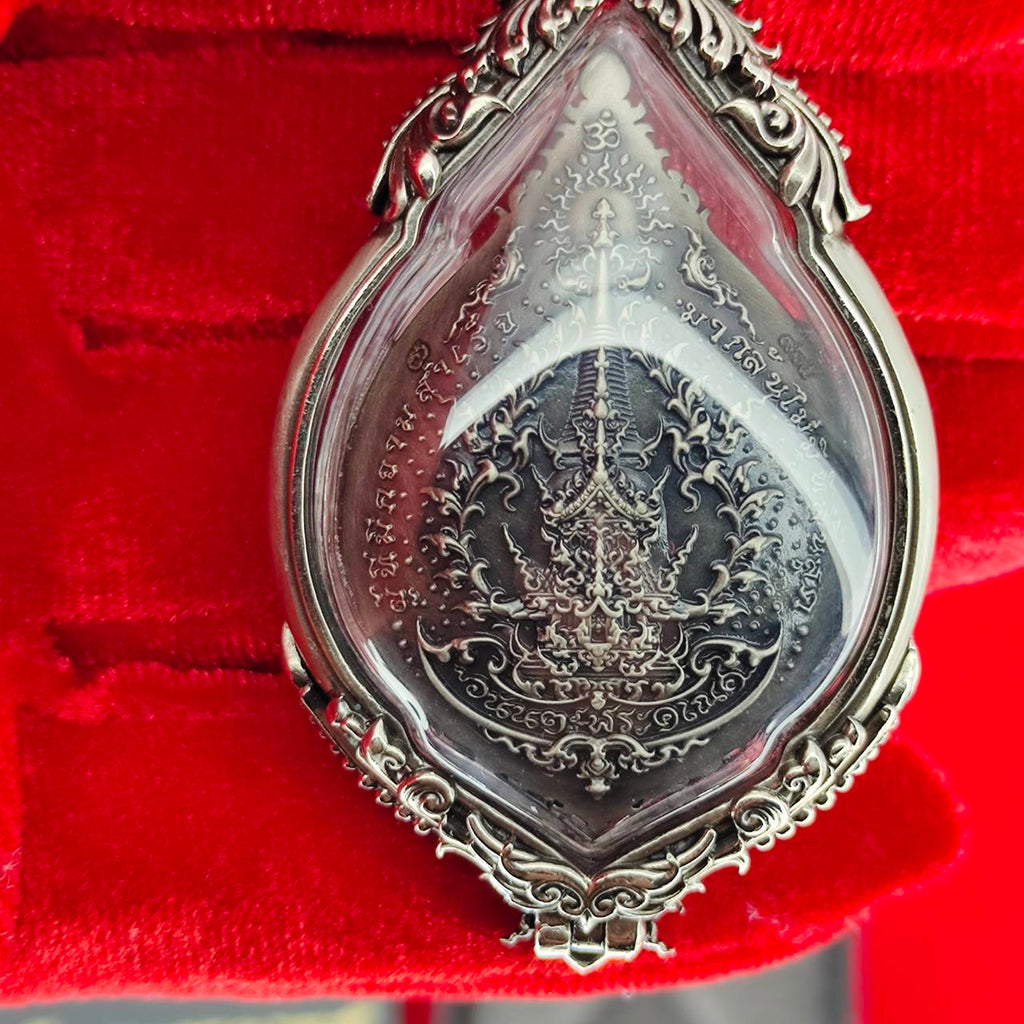 Prosperity Ganesh pendant Thailand featuring intricate silver detailing and a protective glass cover