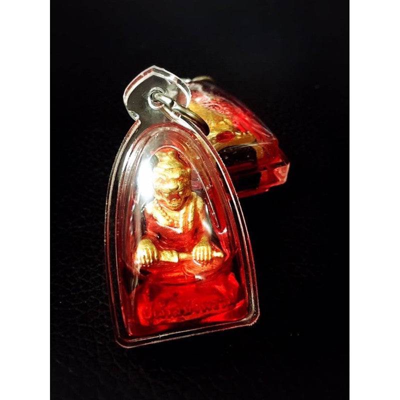 Pu Jao Saming Prai spirit talisman in clear protective case with red and gold figure inside