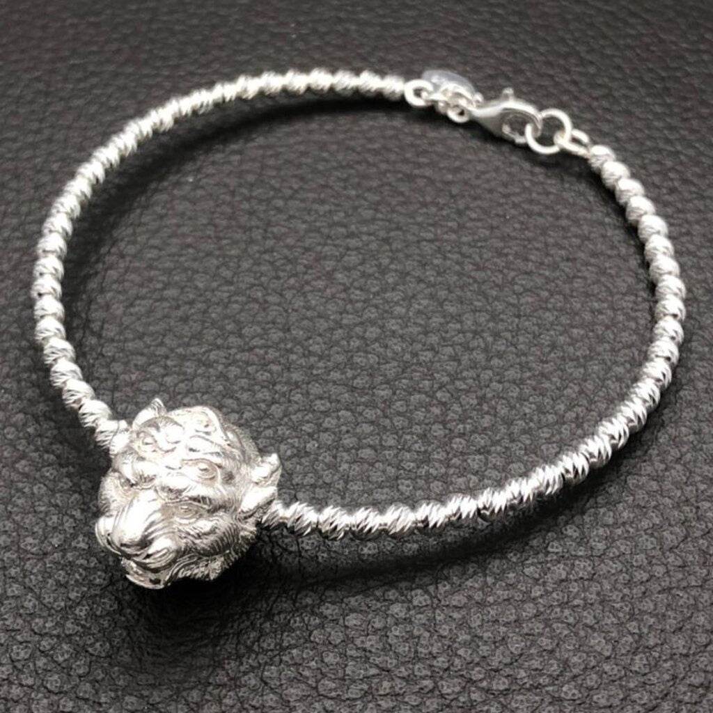 Si Hu Ha Ta bracelet by Master Subin featuring a detailed lion head charm on a twisted silver band