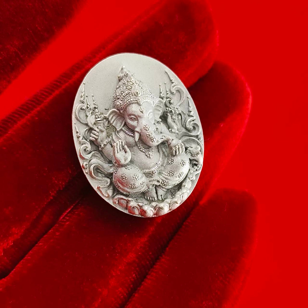 Sacred Ganesha talisman for fortune in intricate design on a red velvet background