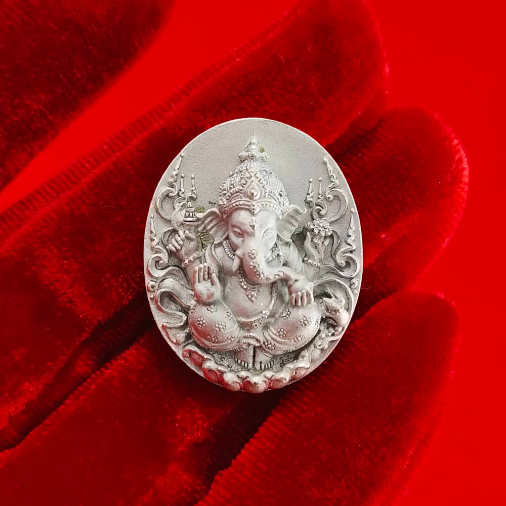 Sacred Ganesha talisman for fortune displayed on a velvet surface, showcasing intricate details