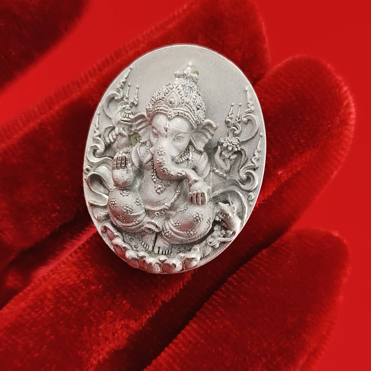 Sacred Ganesha talisman for fortune crafted in silver with intricate detailing and ornate design