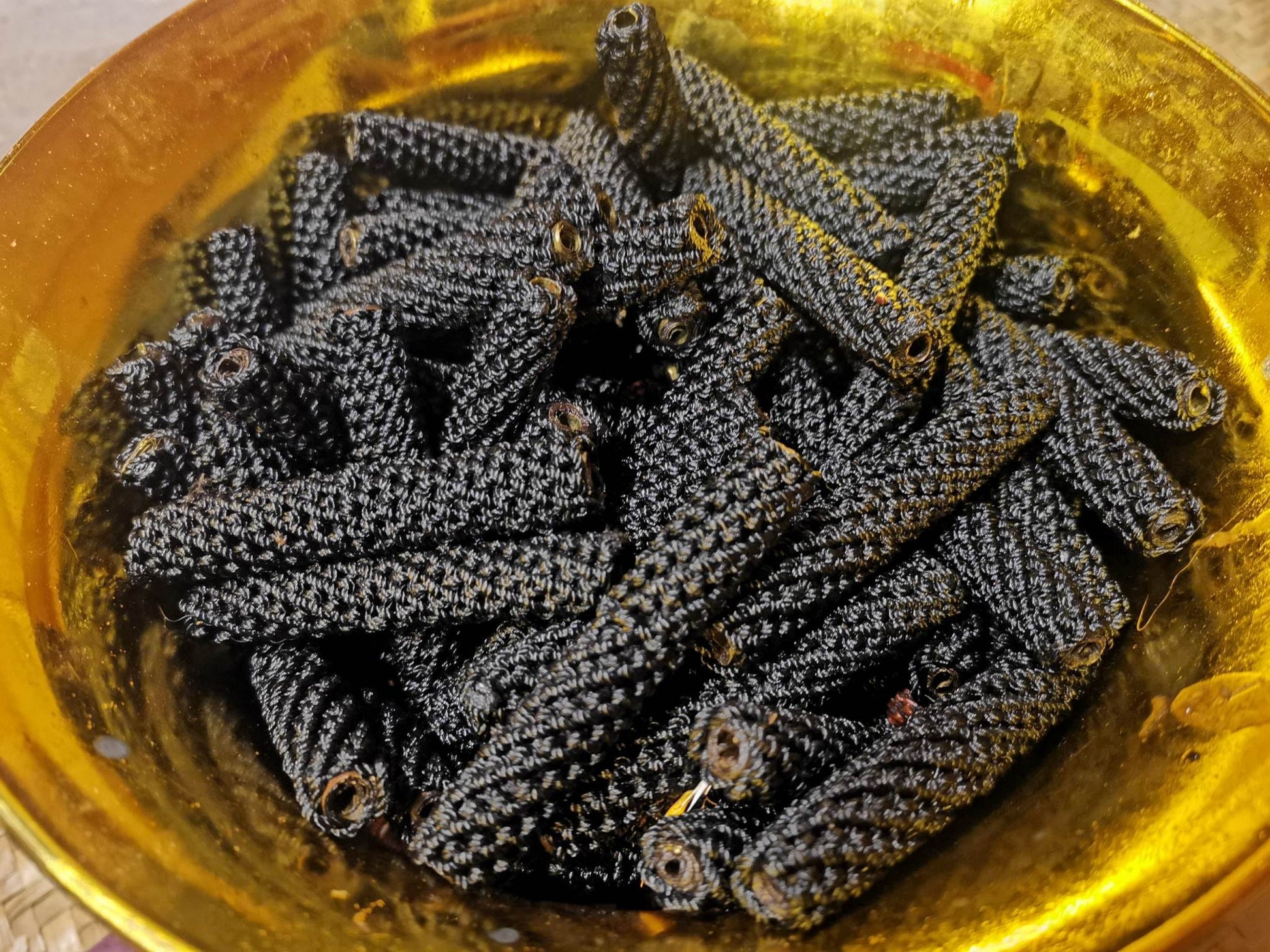 Sacred Thai amulet for good fortune displayed in a golden bowl with intricate details