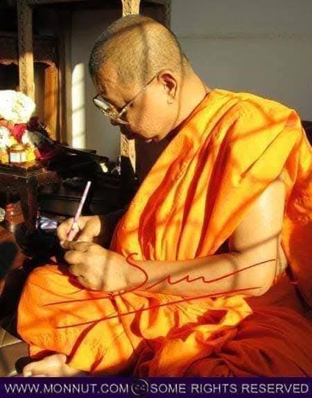 Buddhist monk creating a sacred thai amulet for good fortune surrounded by peaceful setting