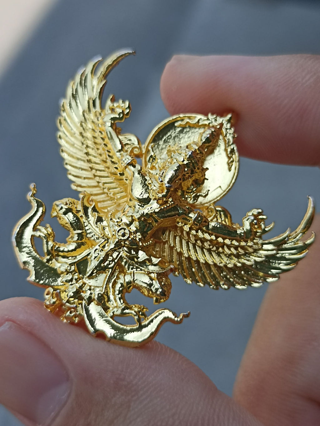 Handcrafted Sacred Thai elephant-bird amulet in gold finish, symbolizing protection and spirituality