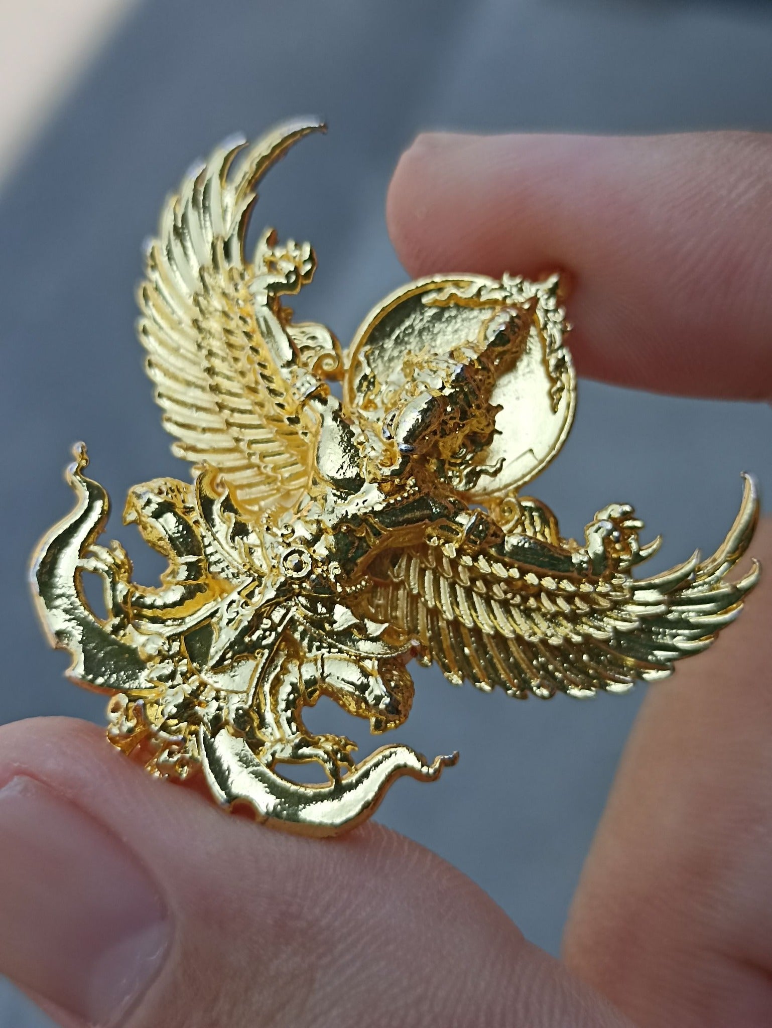 Handcrafted Sacred Thai elephant-bird amulet in gold finish, symbolizing protection and spirituality