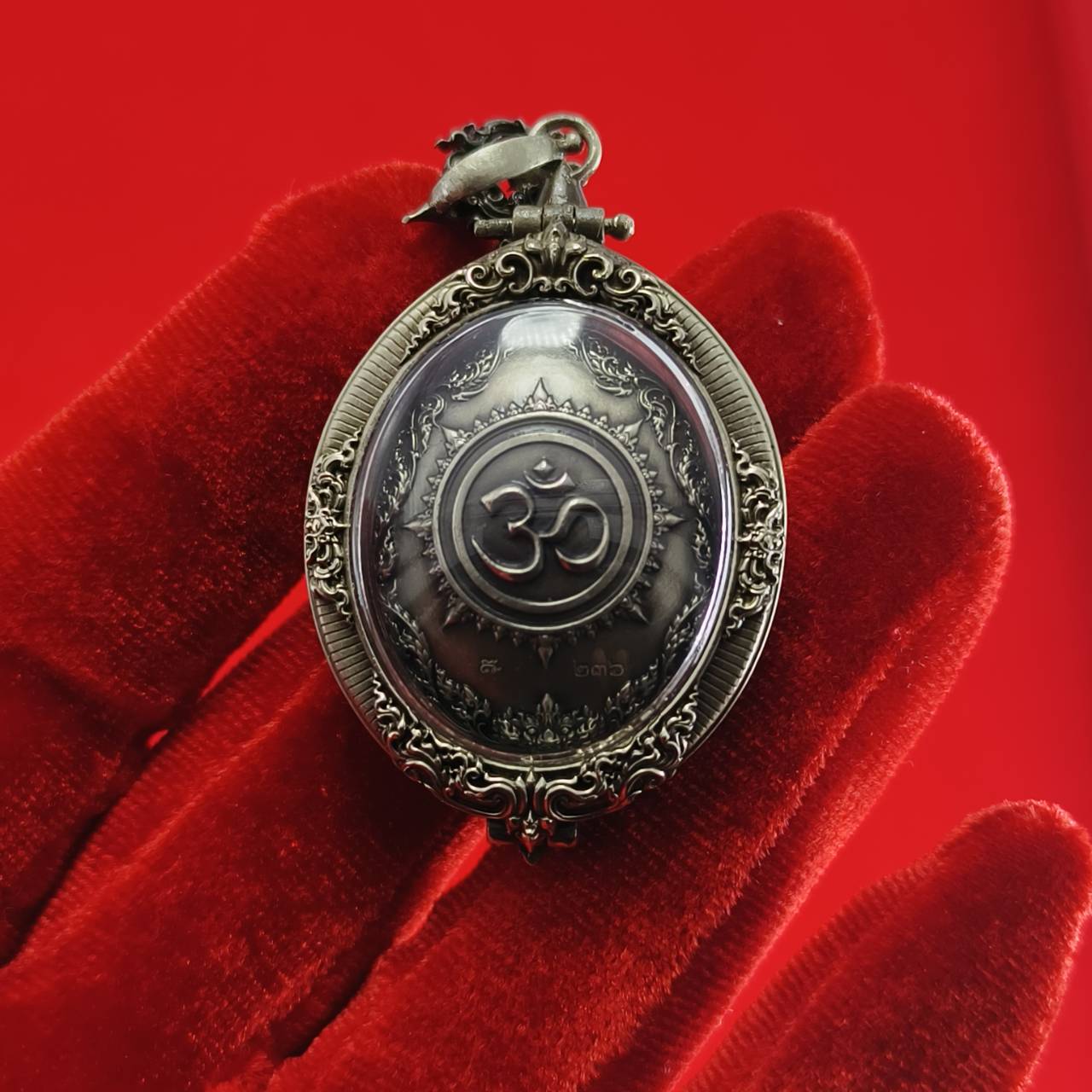 Thai Ganesh pendant white satin gold ornate oval amulet with Om symbol in antique metal on red velvet