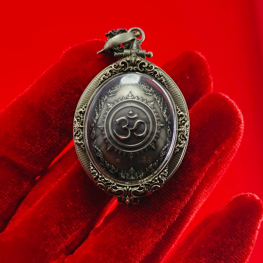 Thai Ganesh pendant white satin gold ornate oval amulet with Om symbol in antique metal frame on red velvet glove