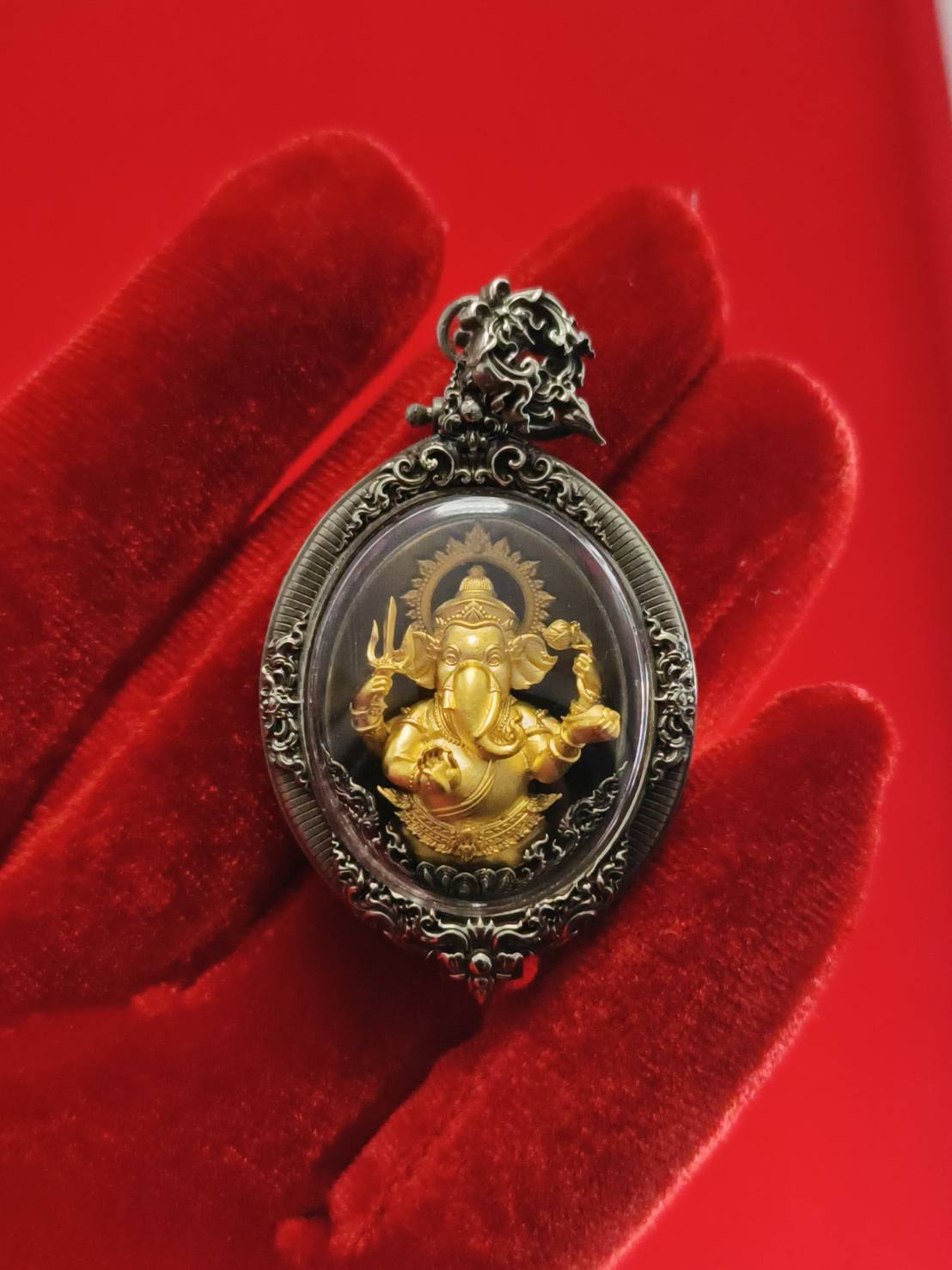 Ornate metal framed Thai Ganesh pendant white satin gold amulet in oval case on red velvet glove