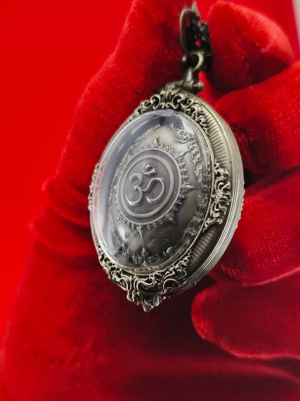 Thai Ganesh pendant white satin gold ornate Om medallion with filigree metal frame on red velvet