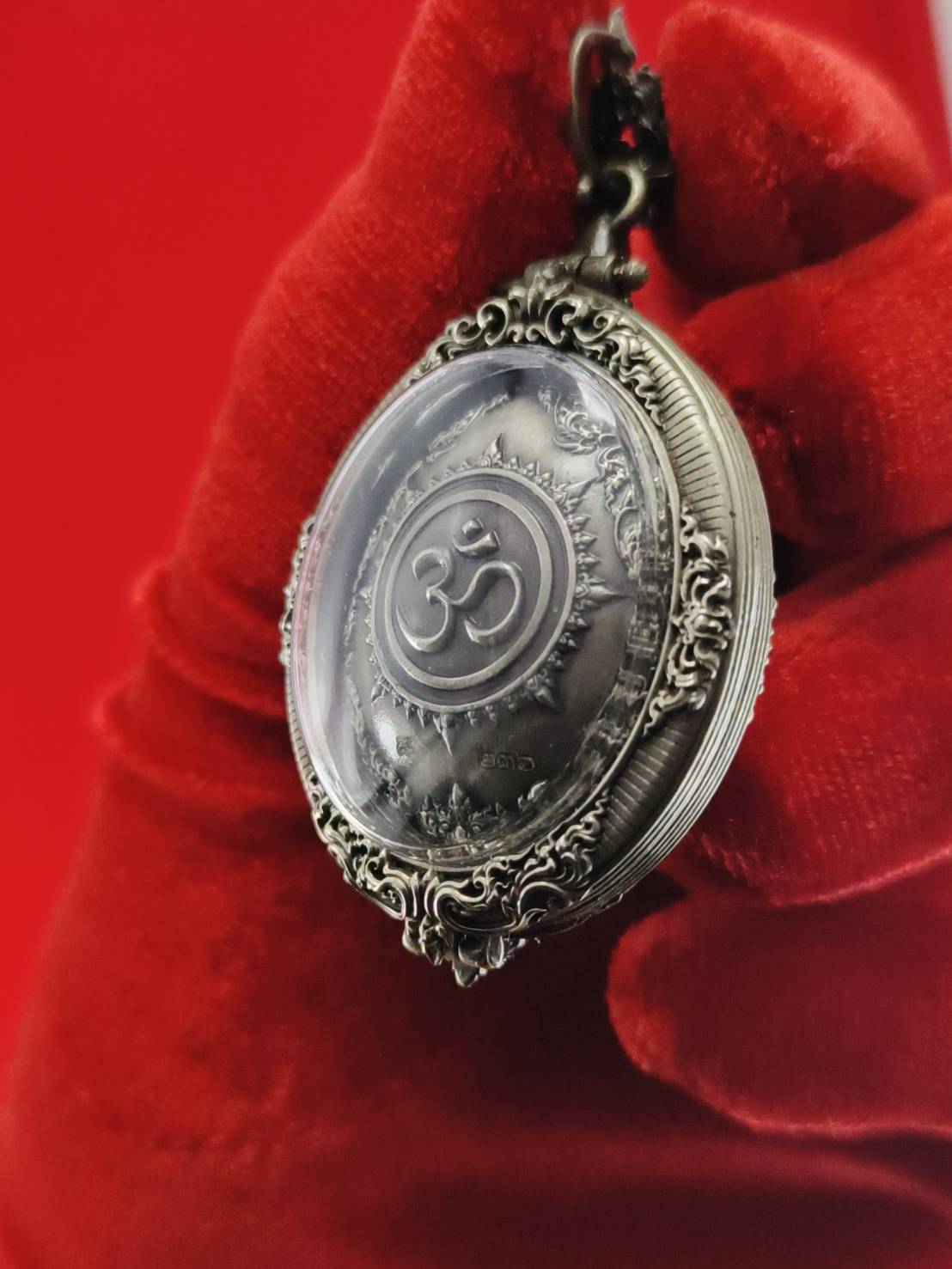 Thai Ganesh pendant white satin gold ornate Om medallion with filigree metal frame on red velvet