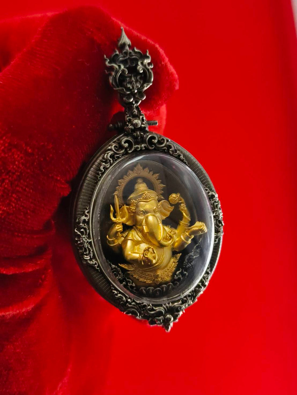 Thai Ganesh pendant white satin gold ornate oval glass amulet with gold Ganesh in silver frame on red velvet