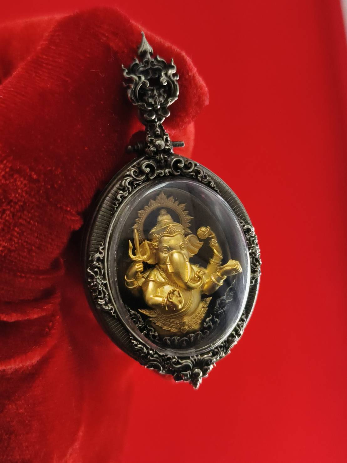 Thai Ganesh pendant white satin gold ornate oval glass amulet with gold Ganesh in silver frame on red velvet