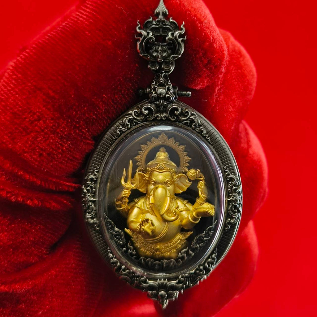 Thai Ganesh pendant white satin gold in ornate silver frame amulet held against red velvet background by Thai Blessing Co