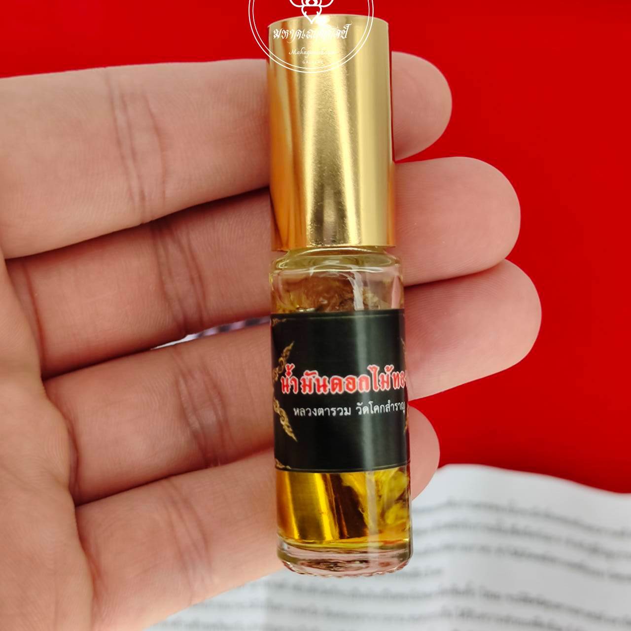 Seductive attraction oil for wealth in a glass bottle with a gold cap by Thai Blessing Co