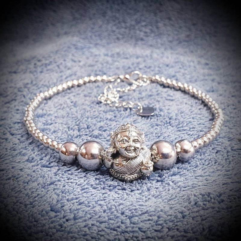 Silver Thai prosperity bracelet for business success featuring a charm and shiny beads