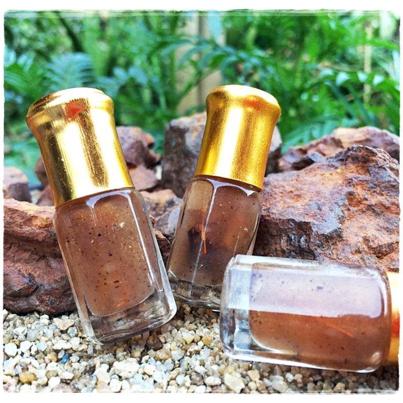 Thai love attraction oil in small glass roll on bottles with gold caps brown herbal massage oil
