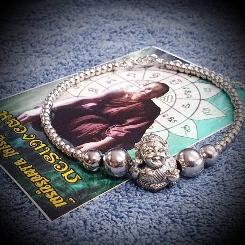Thai prosperity bracelet for business success featuring a silver Buddha charm and polished beads