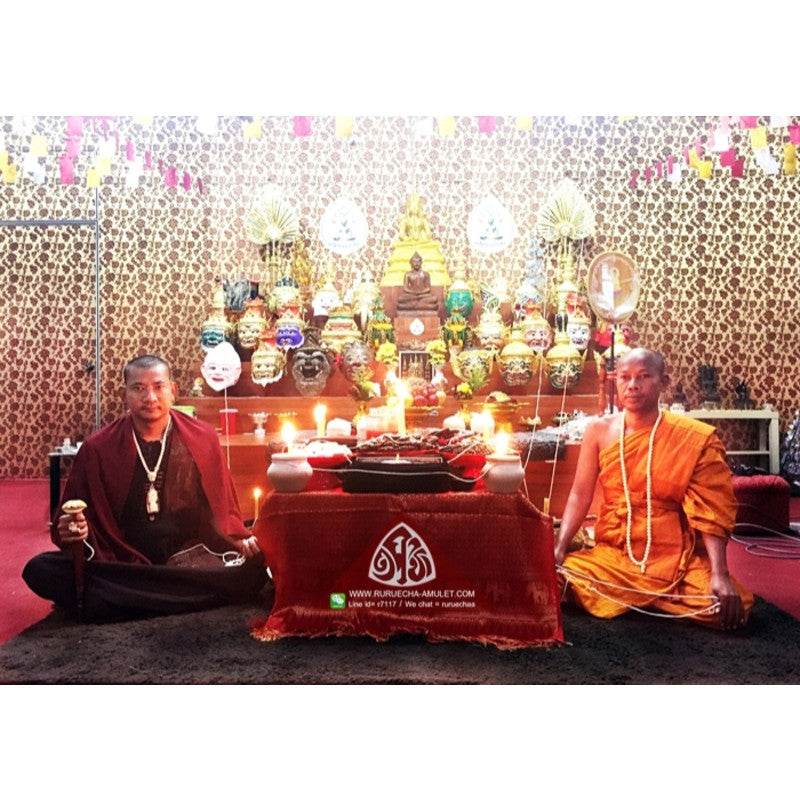 Thai Blessing Co Thai love attraction oil blessed by monks at shrine with candles and Buddha altar
