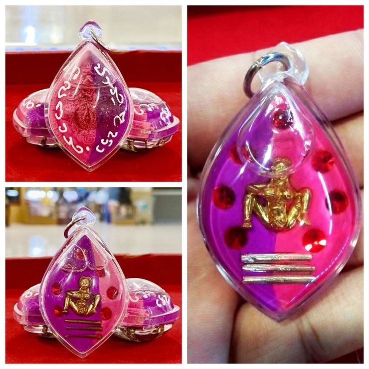 Thai golden face charm pendant with purple background and red dots in clear protective casing