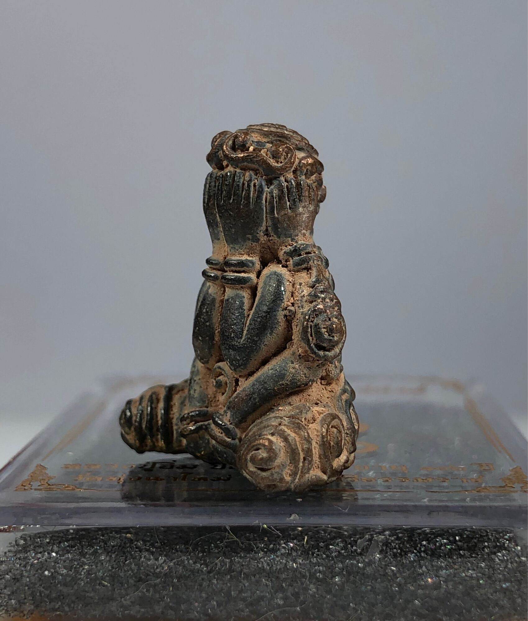 Bronze Phra Pidta Maha Uthom Amulet - Yung Yan (One of Siam's Sacred Symbols) seated figure covering eyes on display base