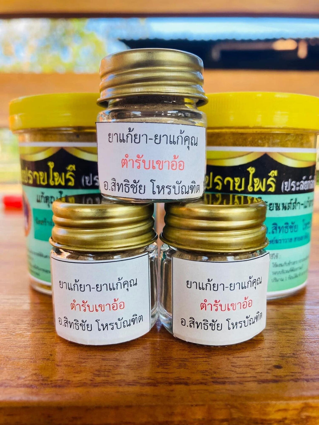 Thai Blessing Co small glass jars of black magic neutralizing herbal medicine for protective charm display