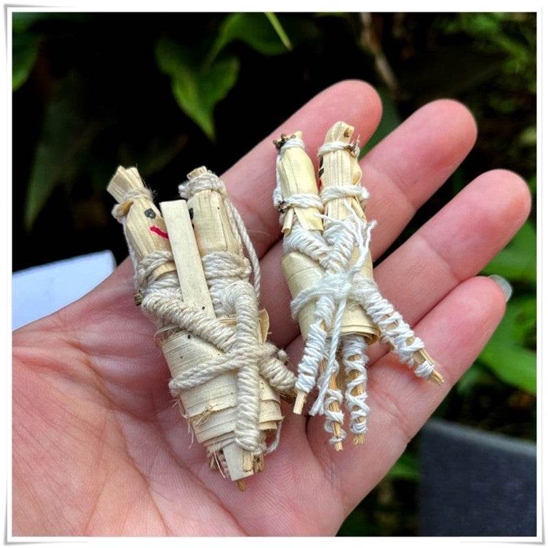 Hand holding spiritual amulet for attraction and relationship wrapped in natural materials