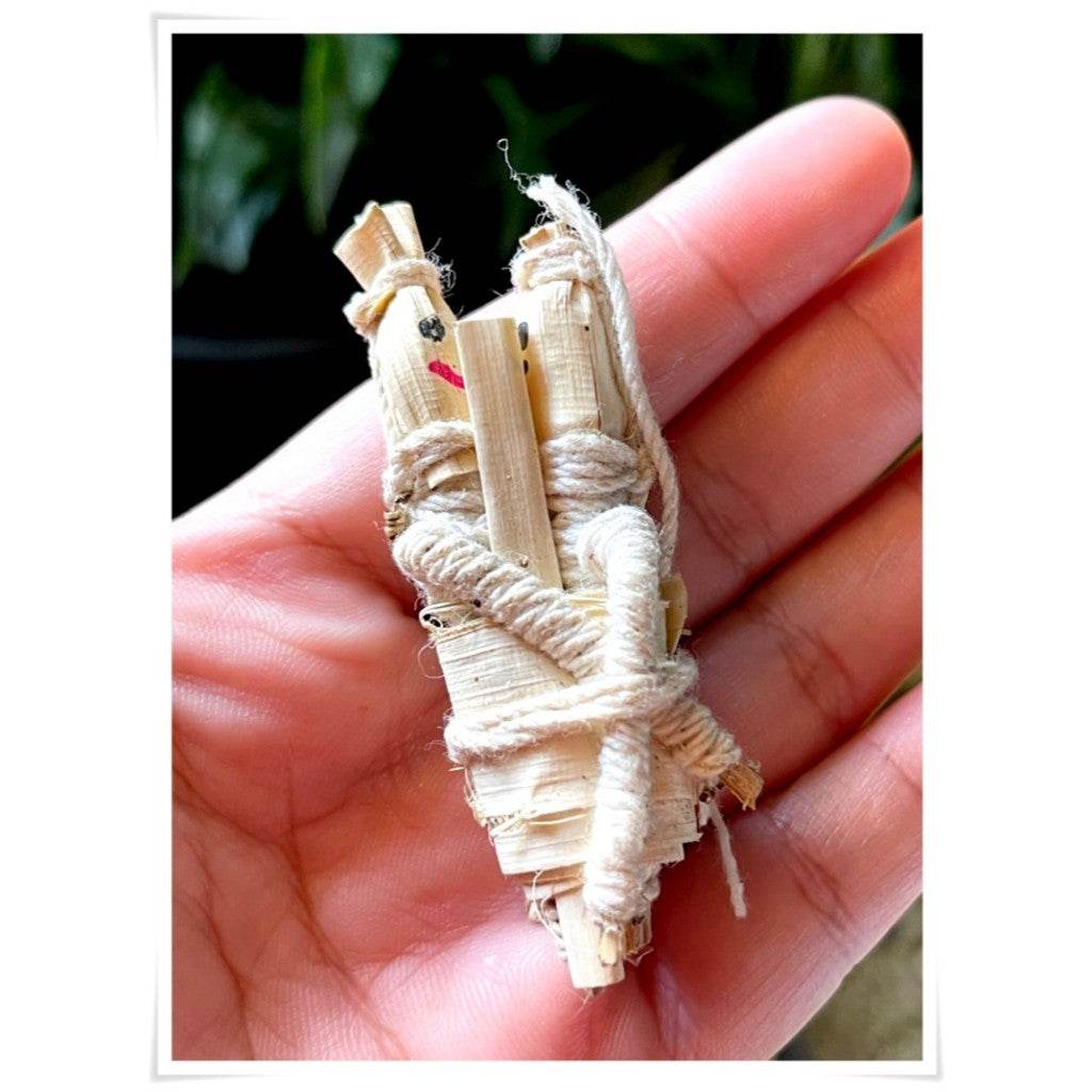 Handheld spiritual amulet for attraction and relationship made from natural materials, enhancing positive energy.