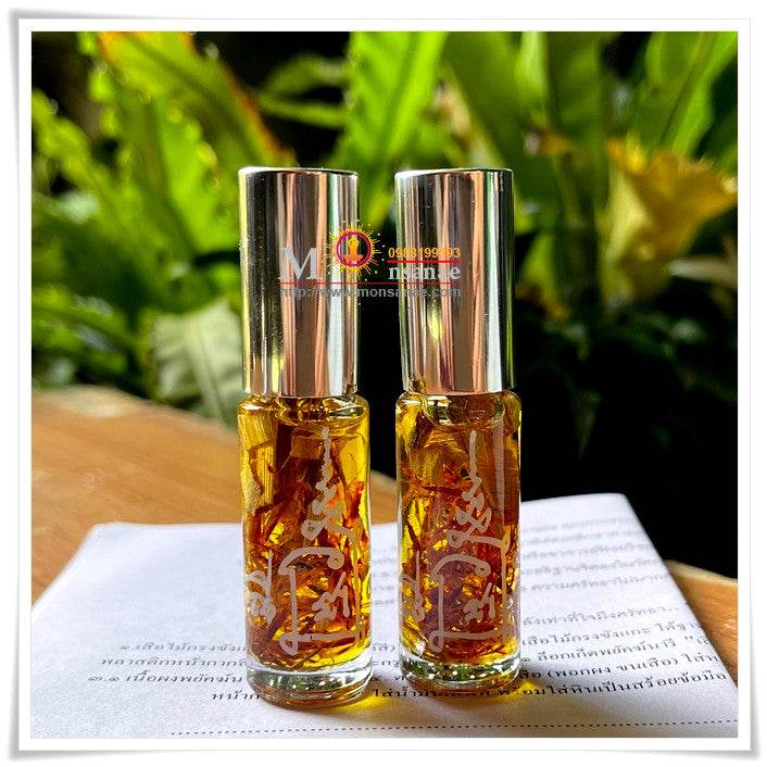 Two bottles of spiritual oil for grace and attraction with floral ingredients and decorative labels